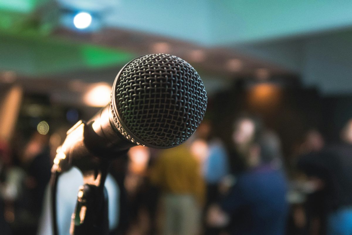 Press conference with microphones and media coverage